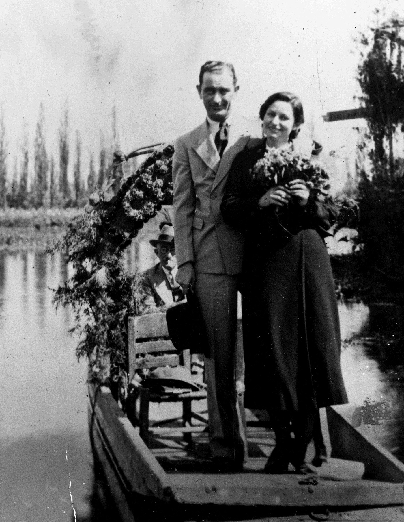 Newlyweds Lyndon B. Johnson and Lady Bird Johnson posing in a boat on the Floating Gardens in Xochimilco, Mexico in November 1934.