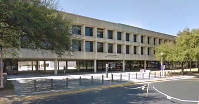 Image of the LBJ Library through the walkway from the parking lot.