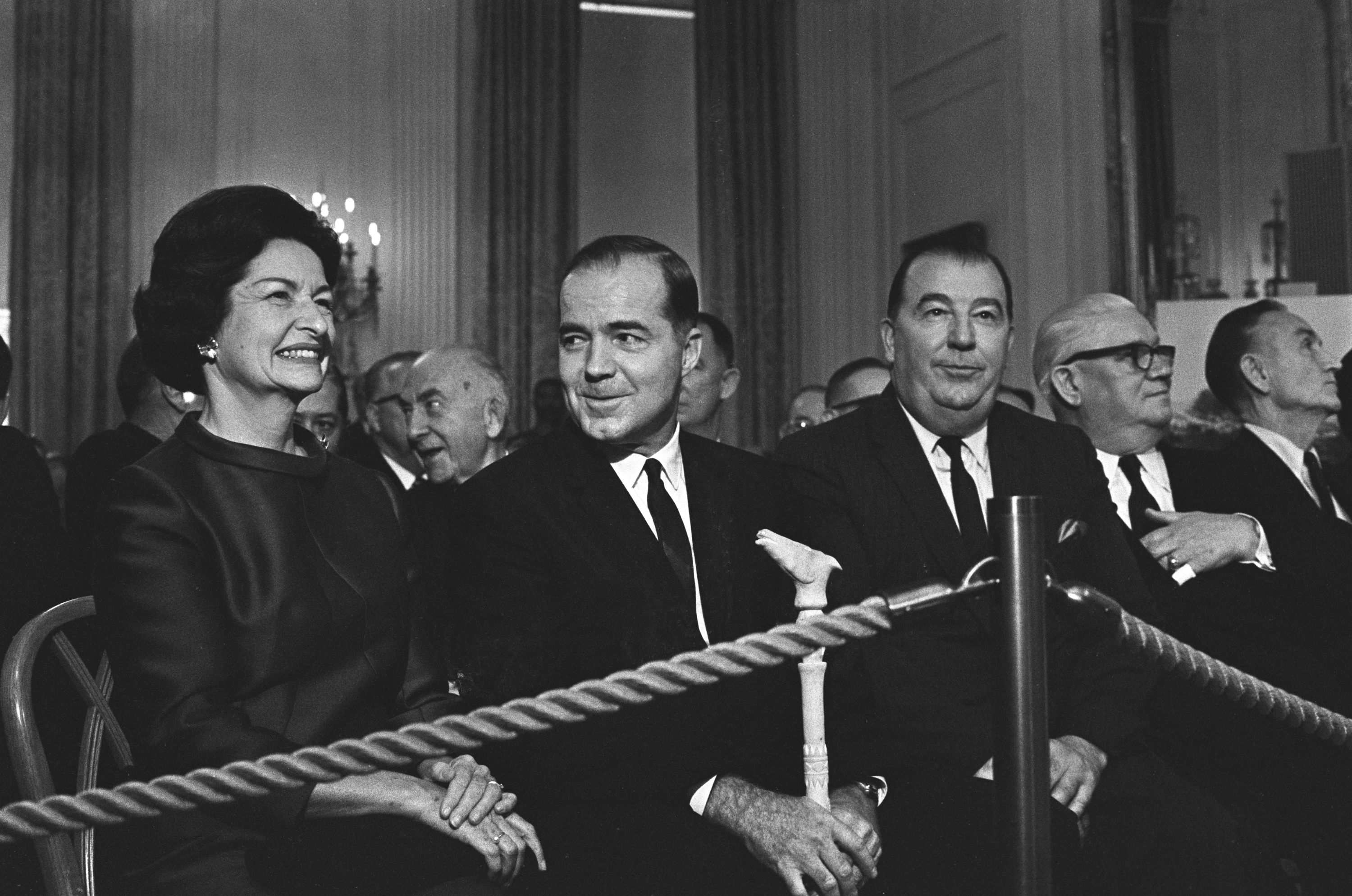 Lady Bird Johnson listens to President Lyndon B. Johnson (not in frame) speaking at the signing ceremony for the Highway Beautification Act.