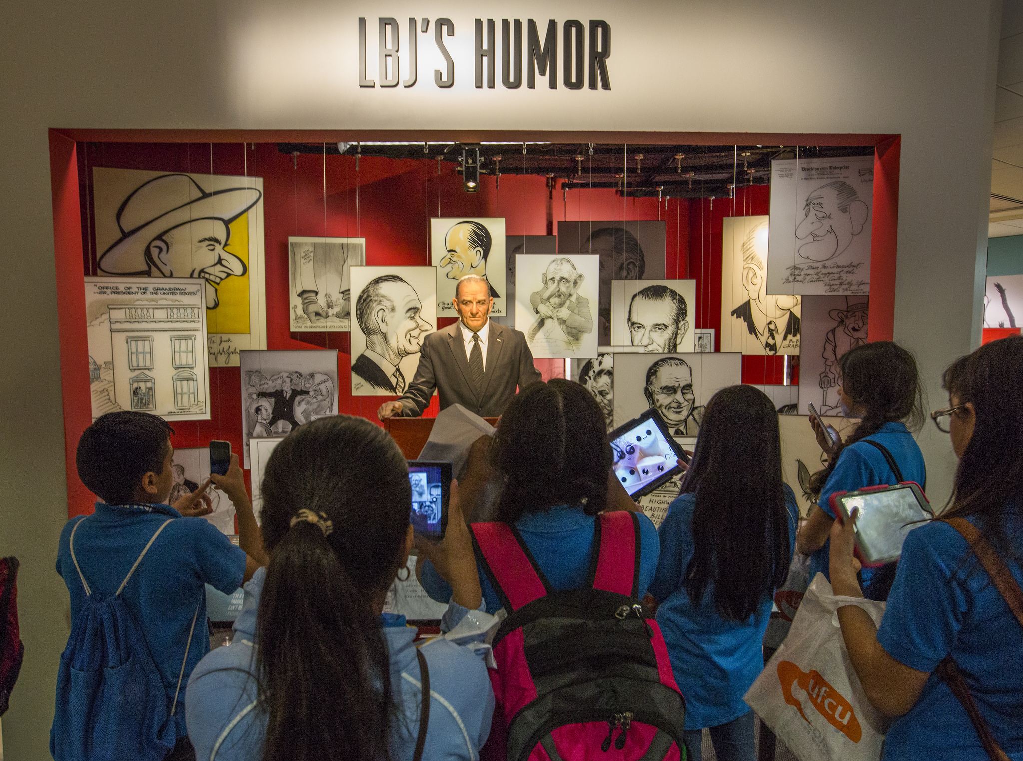Student visitors view the LBJ's Humor exhibition at the LBJ Library.