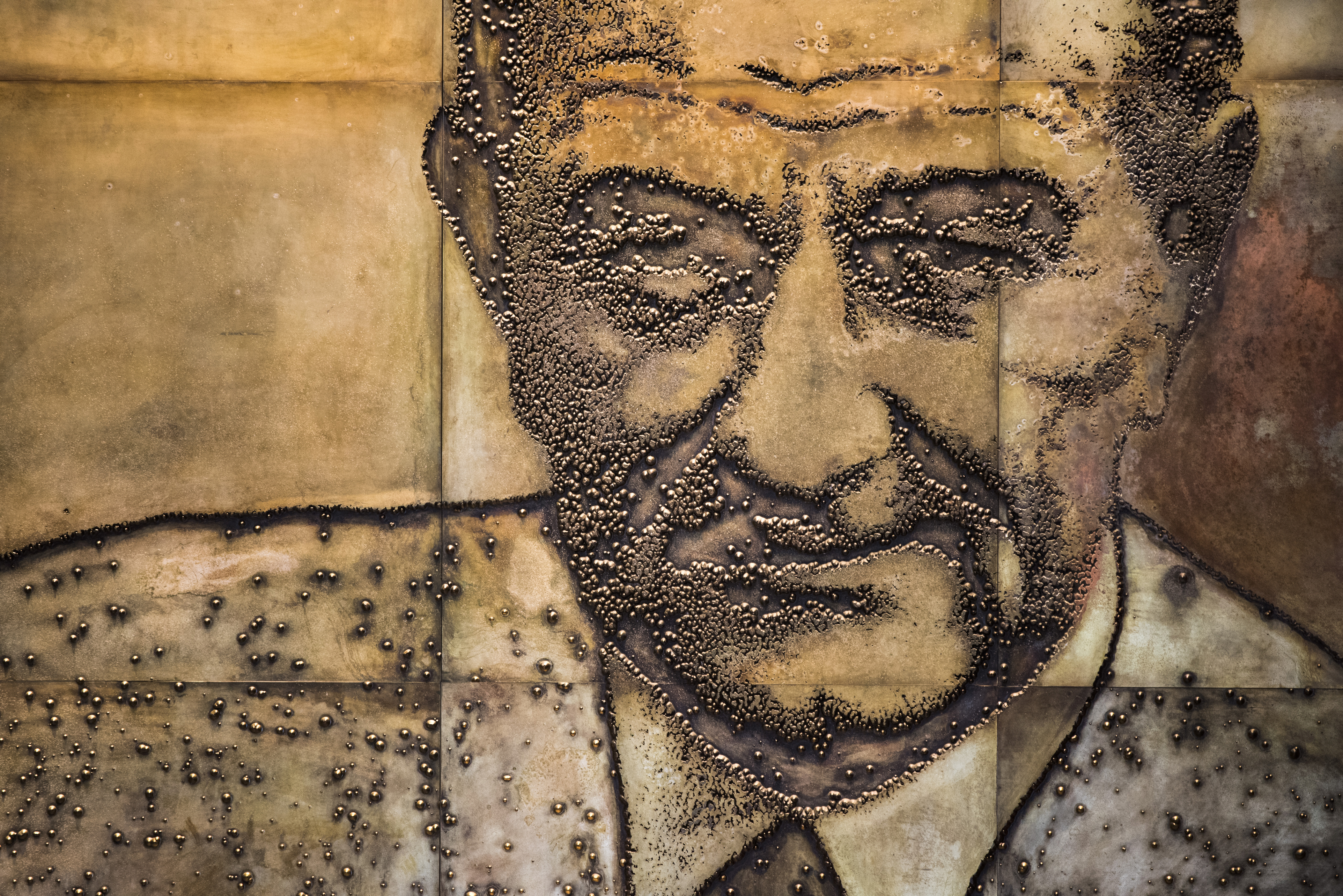 A section of a 50-foot-long mural that shows Lyndon Johnson a various stages of his career.