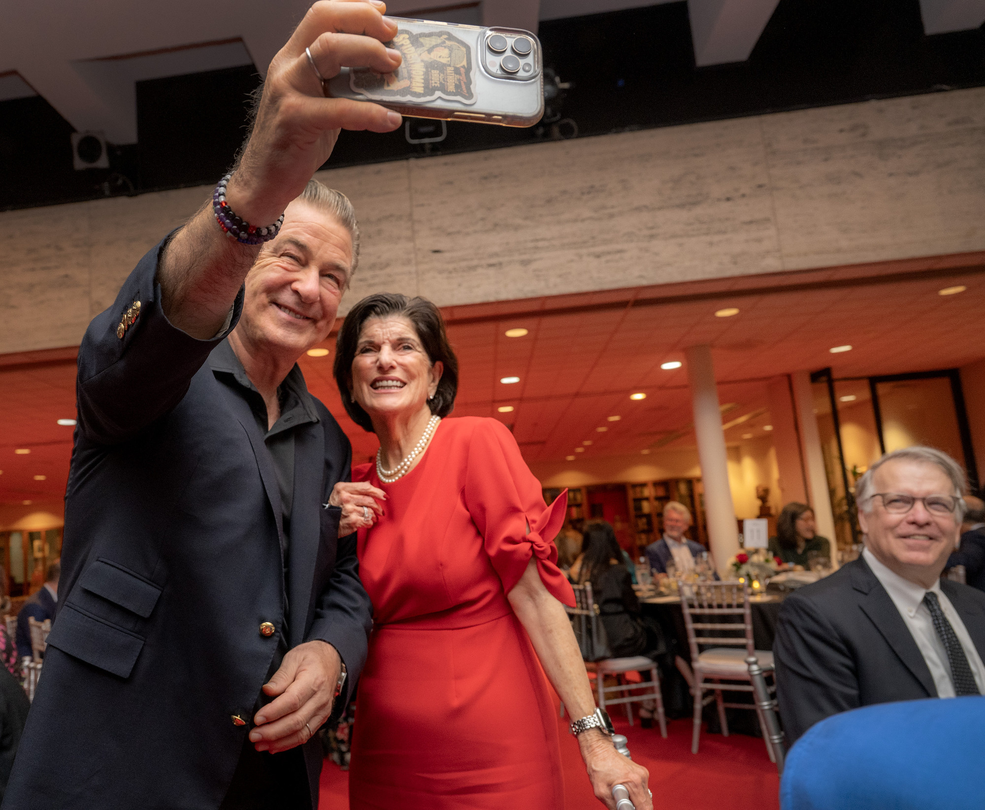 Alec Baldwin takes a photo with Luci Baines Johnson