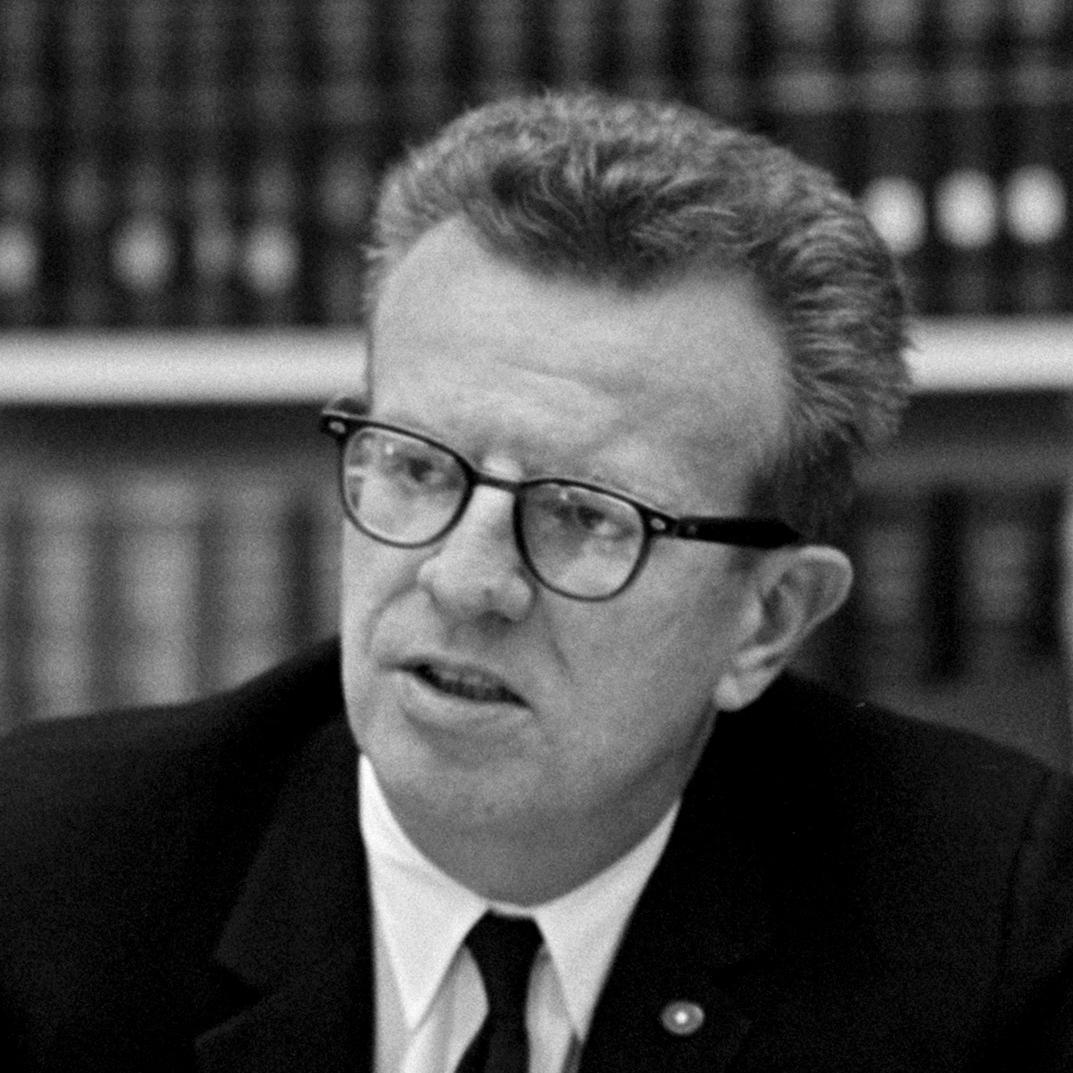 Lawrence O'Brien sits at a table during a meeting.