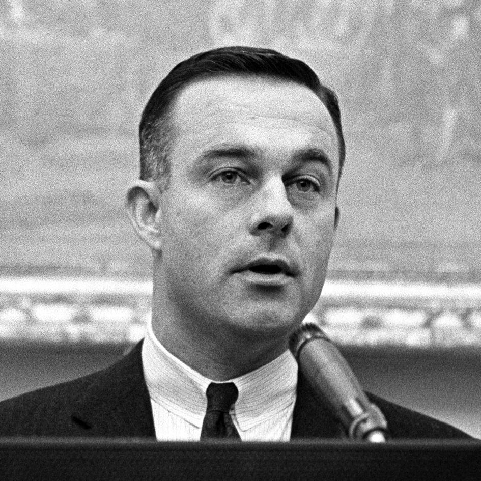 Alexander B. Trowbridge makes remarks from a podium.