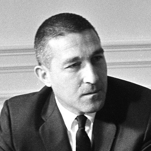 Close up of Sec. Stewart Udall in a meeting with President Johnson (out of frame) in the Oval Office