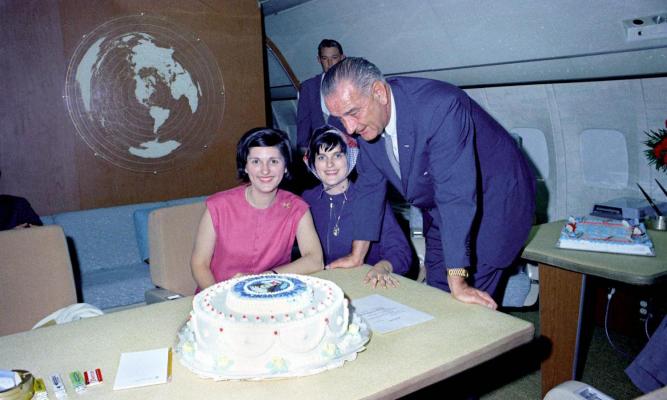 President Lyndon B. Johnson with his birthday cake and daughters Lynda Johnson (left) and Luci Johnson (right). LBJ Library photo by Donald Stoderl #C405-9a.