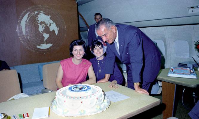 President Lyndon B. Johnson with his birthday cake and daughters Lynda Johnson (left) and Luci Johnson (right). LBJ Library photo by Donald Stoderl #C405-9a-WH65.