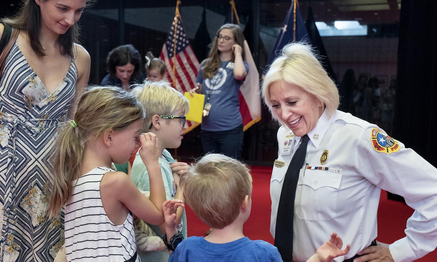 Austin Fire Chief Rhoda Mae Kerr visits with siblings Calli, Cole and Christian (l-r) during the Summer Storytime Series at the LBJ Presidential Library on Friday, August 11, 2017 at the University of Texas in Austin, TX.