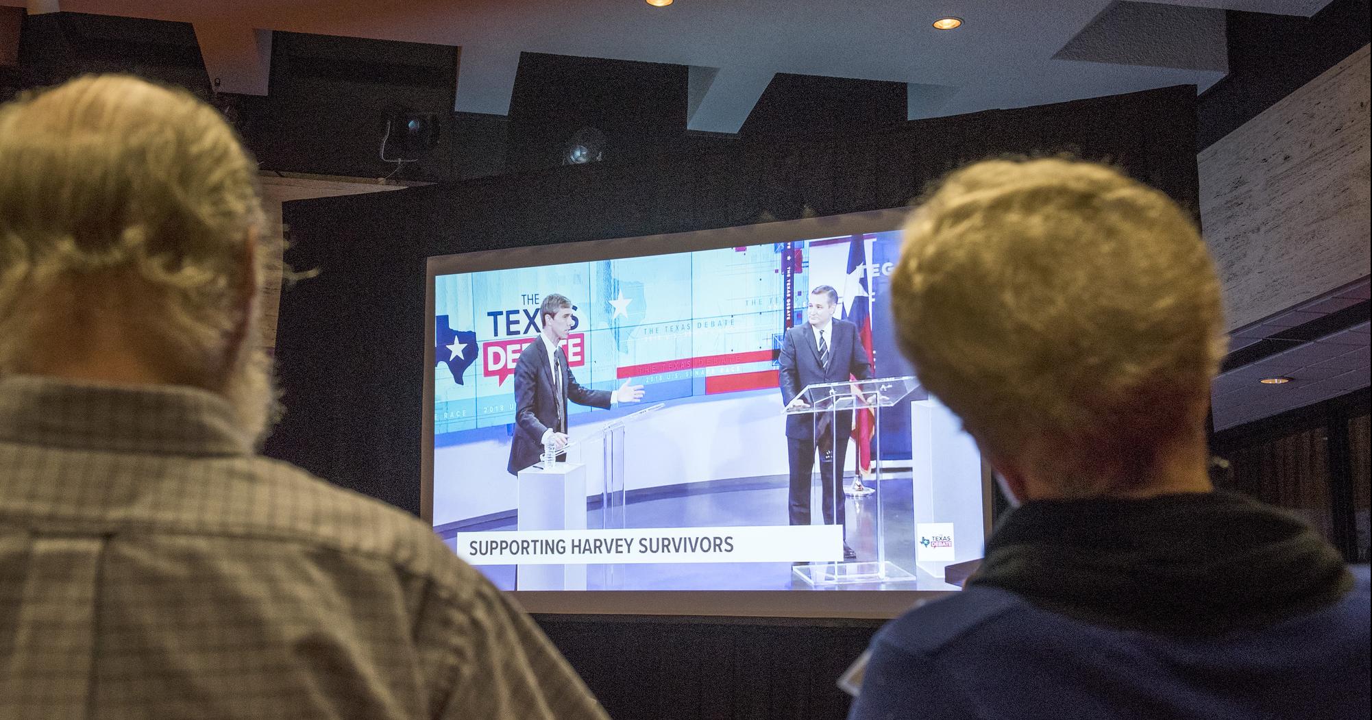 Two participants watch the debate after the panel concluded.