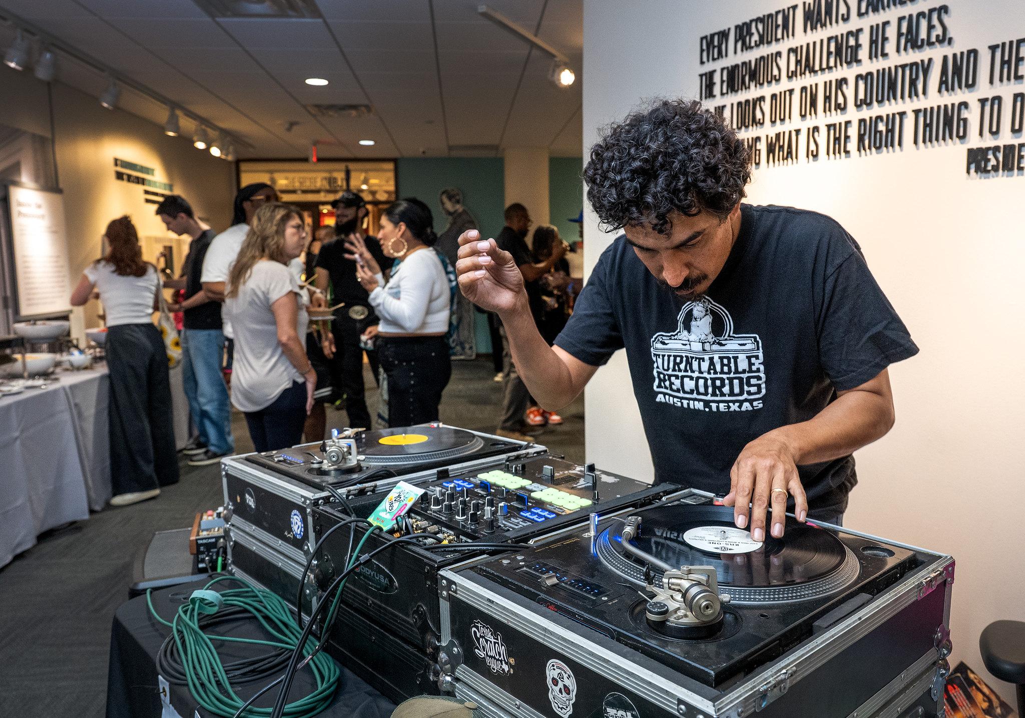 DJ Abe Hernandez mixes music for the event.